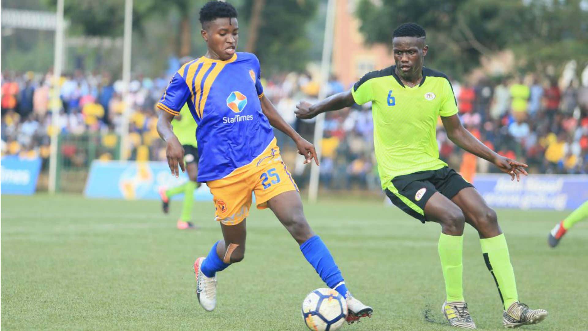 KCCA FC striker Allan Okello shields the ball from his Proline FC’s Arnold Sserunjogi.