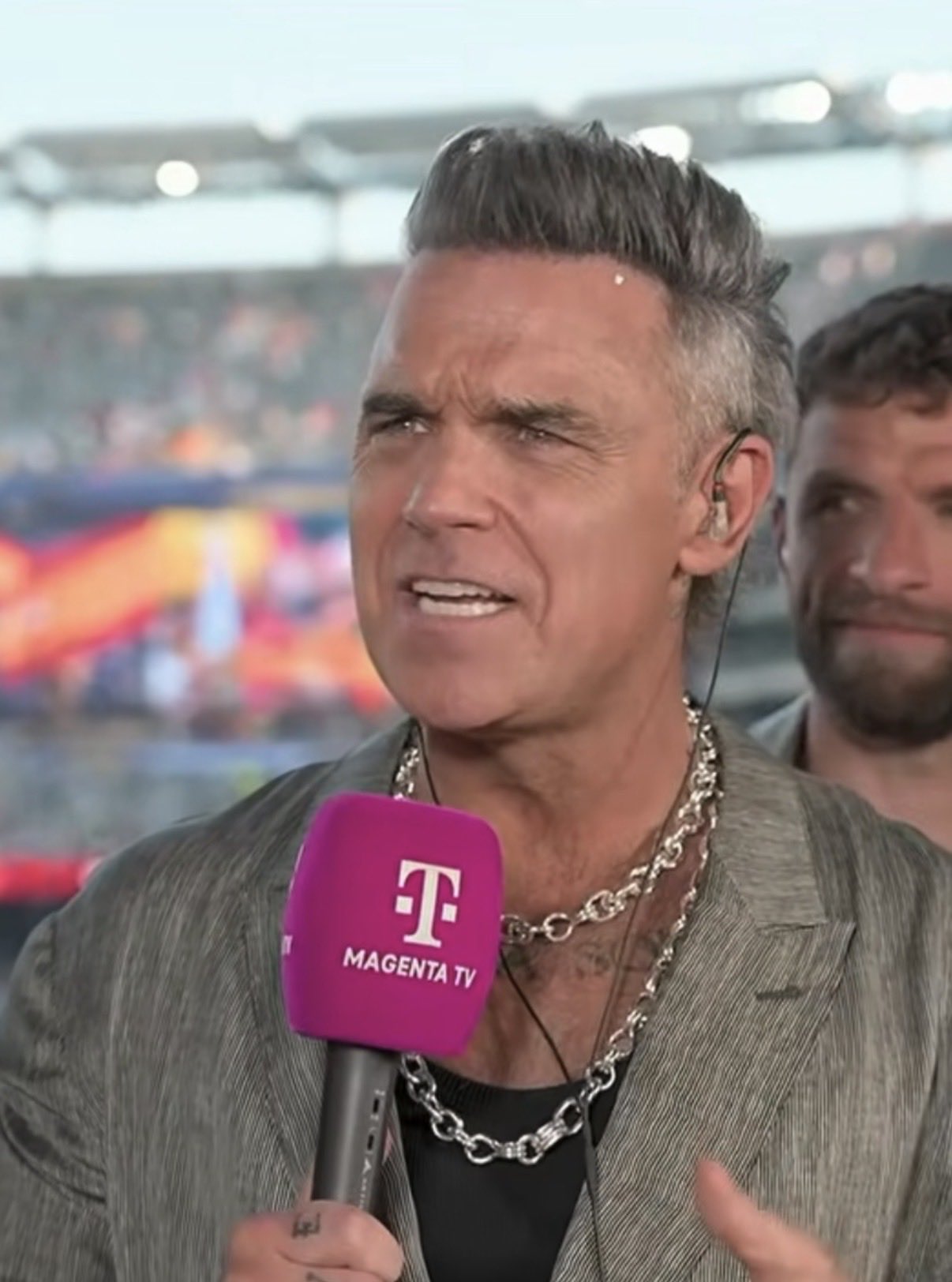 Mystery solved as Robbie Williams responds to 'white substance falling on mic' live on TV