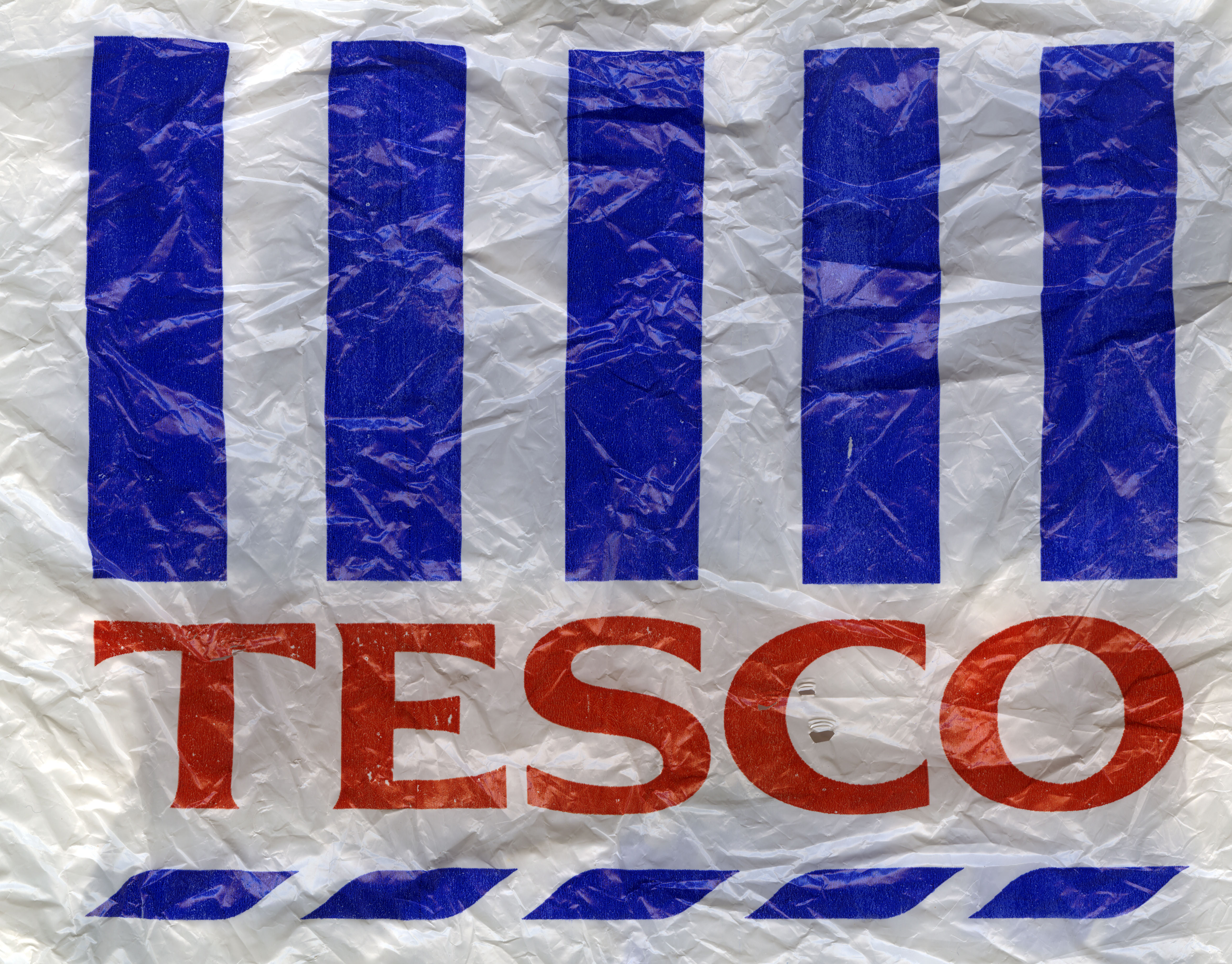 Tesco white and blue plastic shopping bag Stock Photo - Alamy