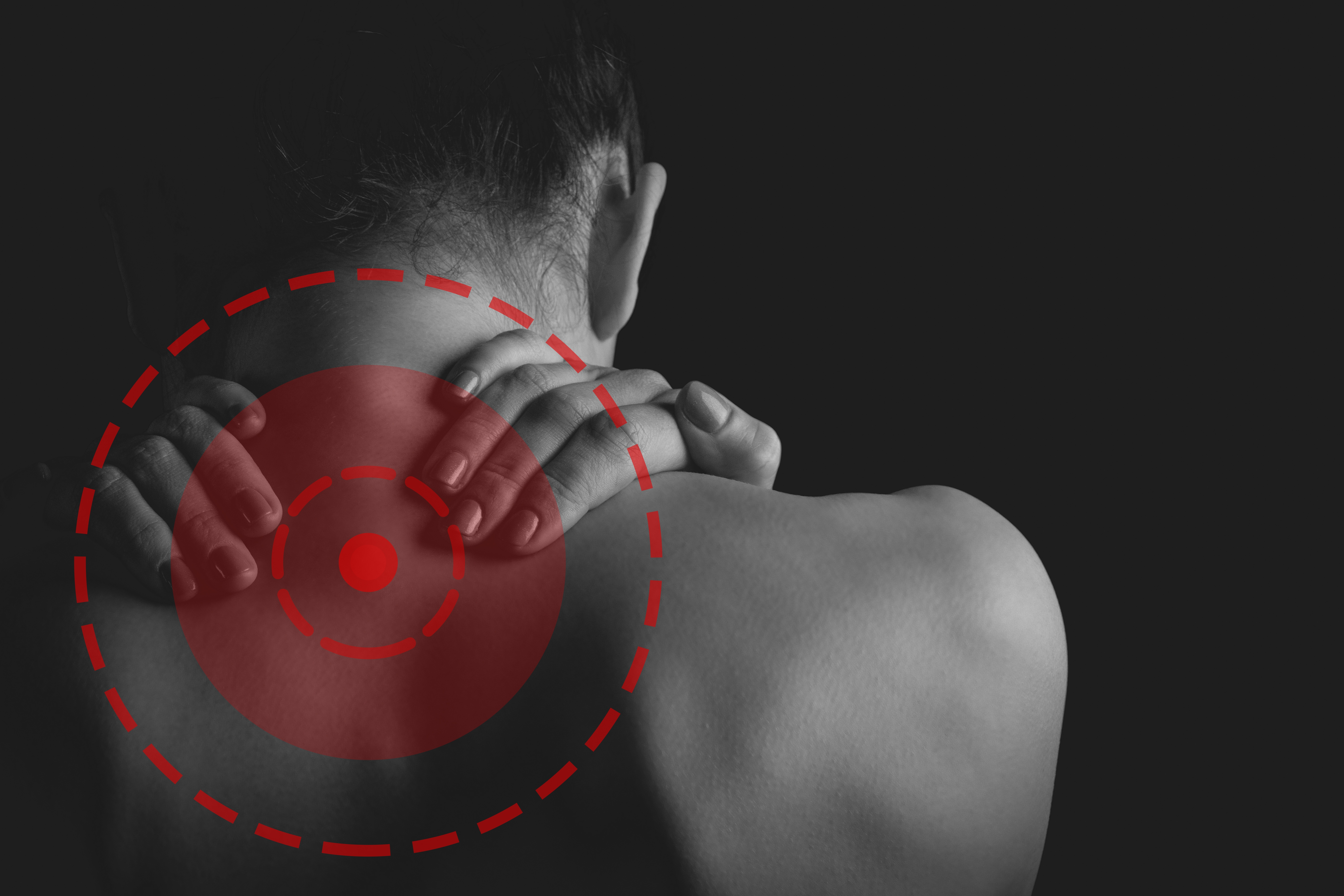 person holding his neck and shoulder with both hands