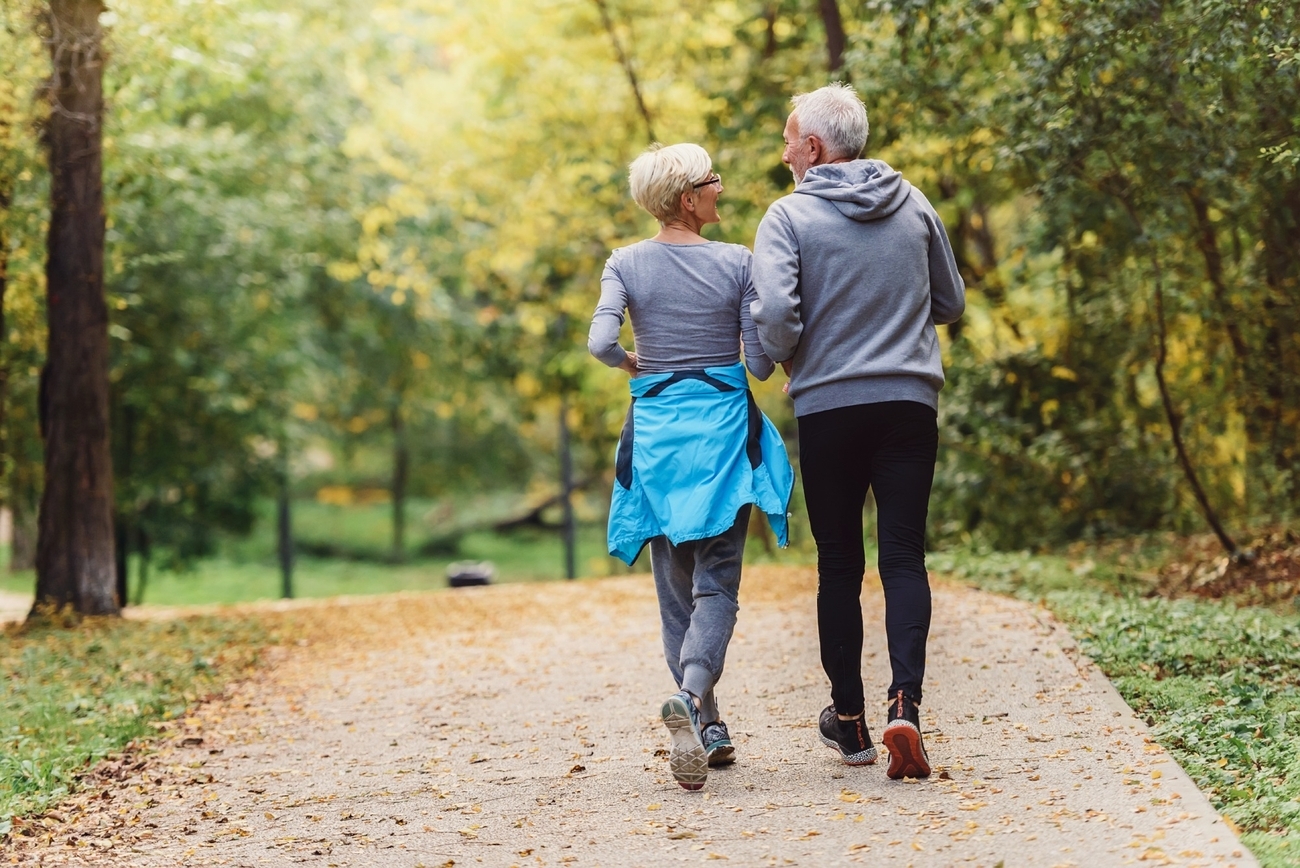 Mature couple taking a peaceful walk surrounded by nature.