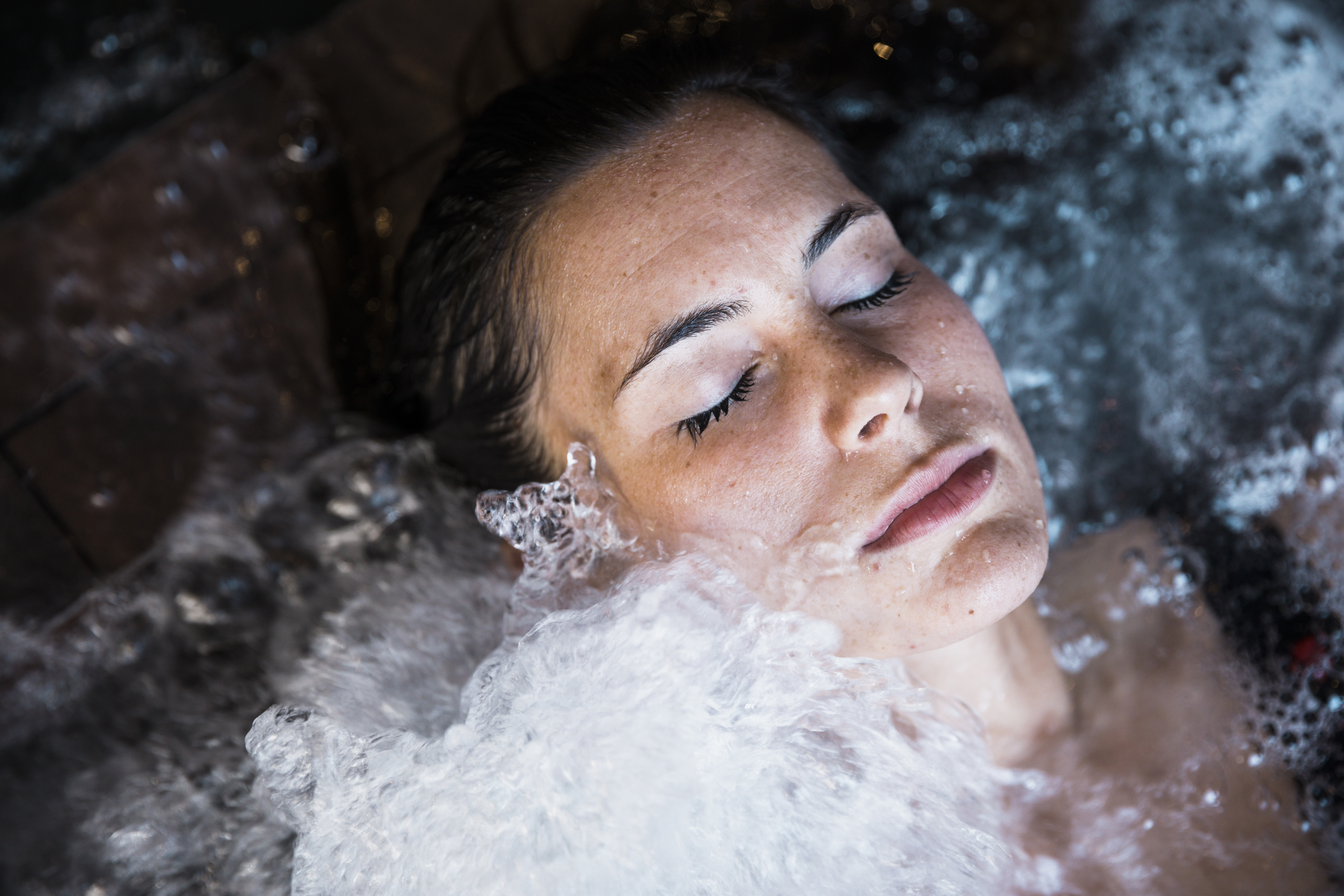 Woman closing her eyes while in a cold bath.