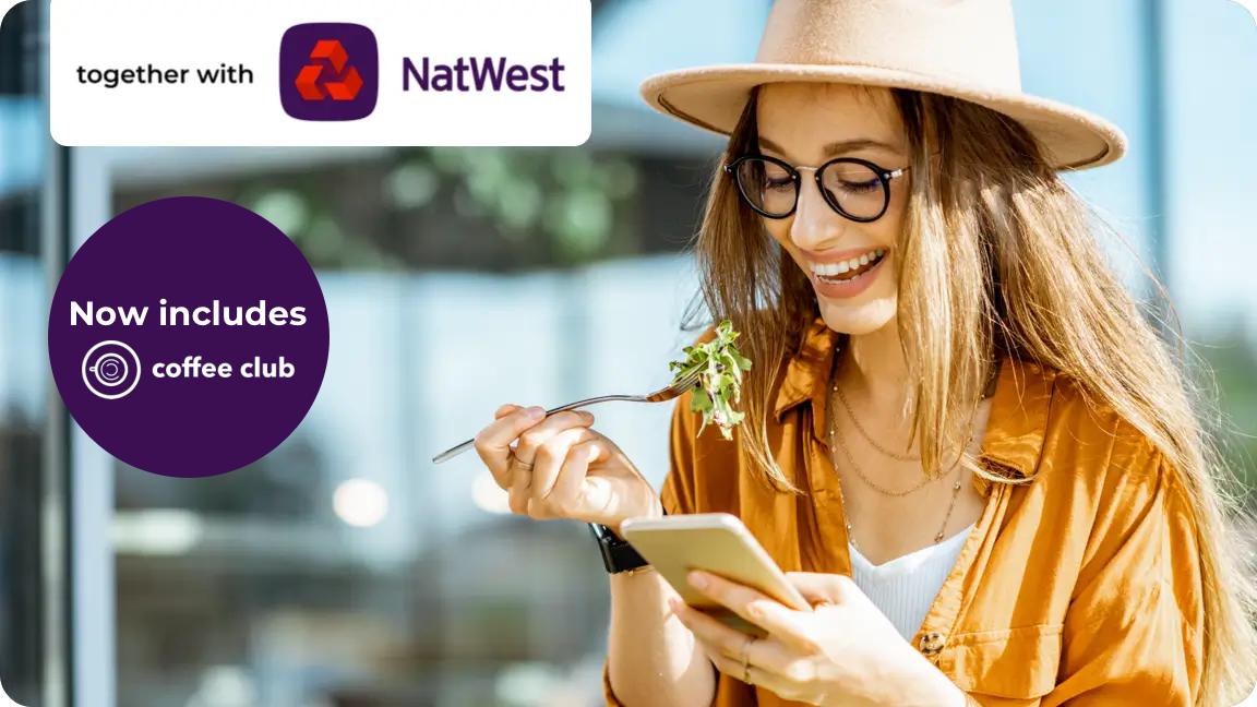 Woman eating salad and holding her phone