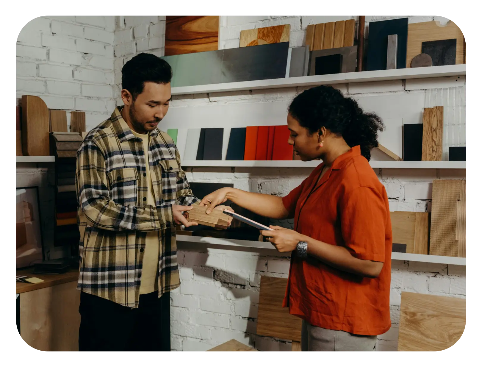 A shop owner showing her products to a customer