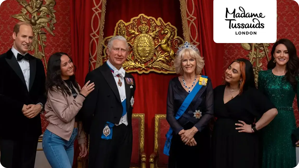 Friends enjoying a picture with the royal family at Madame Tussauds