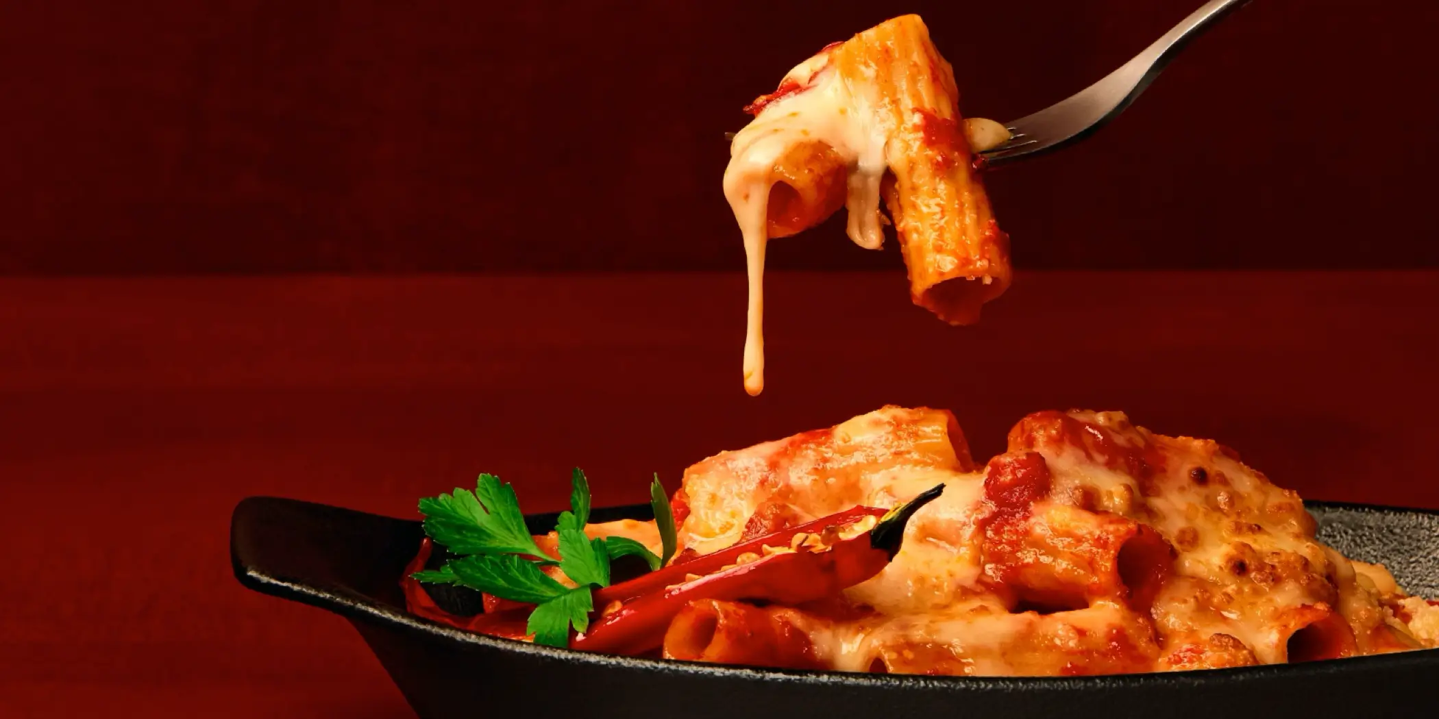 Spicy tomato pasta with dripping cheese off the fork