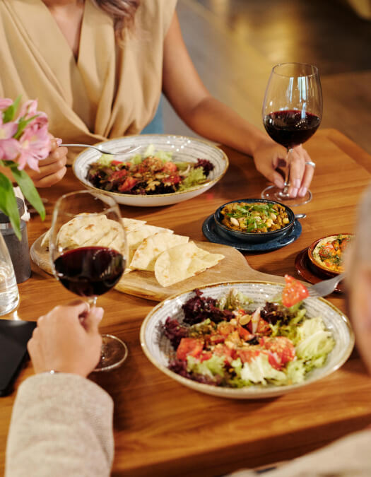 Friends cheering cocktails over a tapas dinner