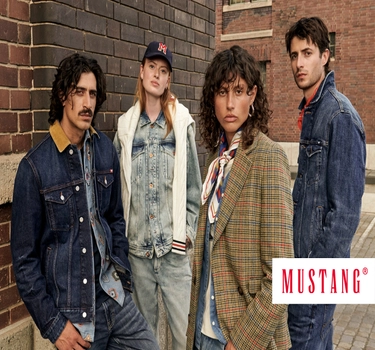 Four people standing next to each other with Denim jackets and jeans. 