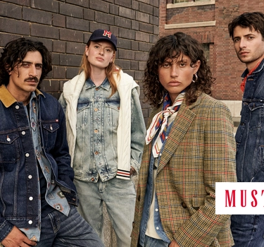 Four people standing next to each other with Denim jackets and jeans.