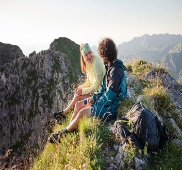 Man and Woman in Vaude clothes in the mountains
