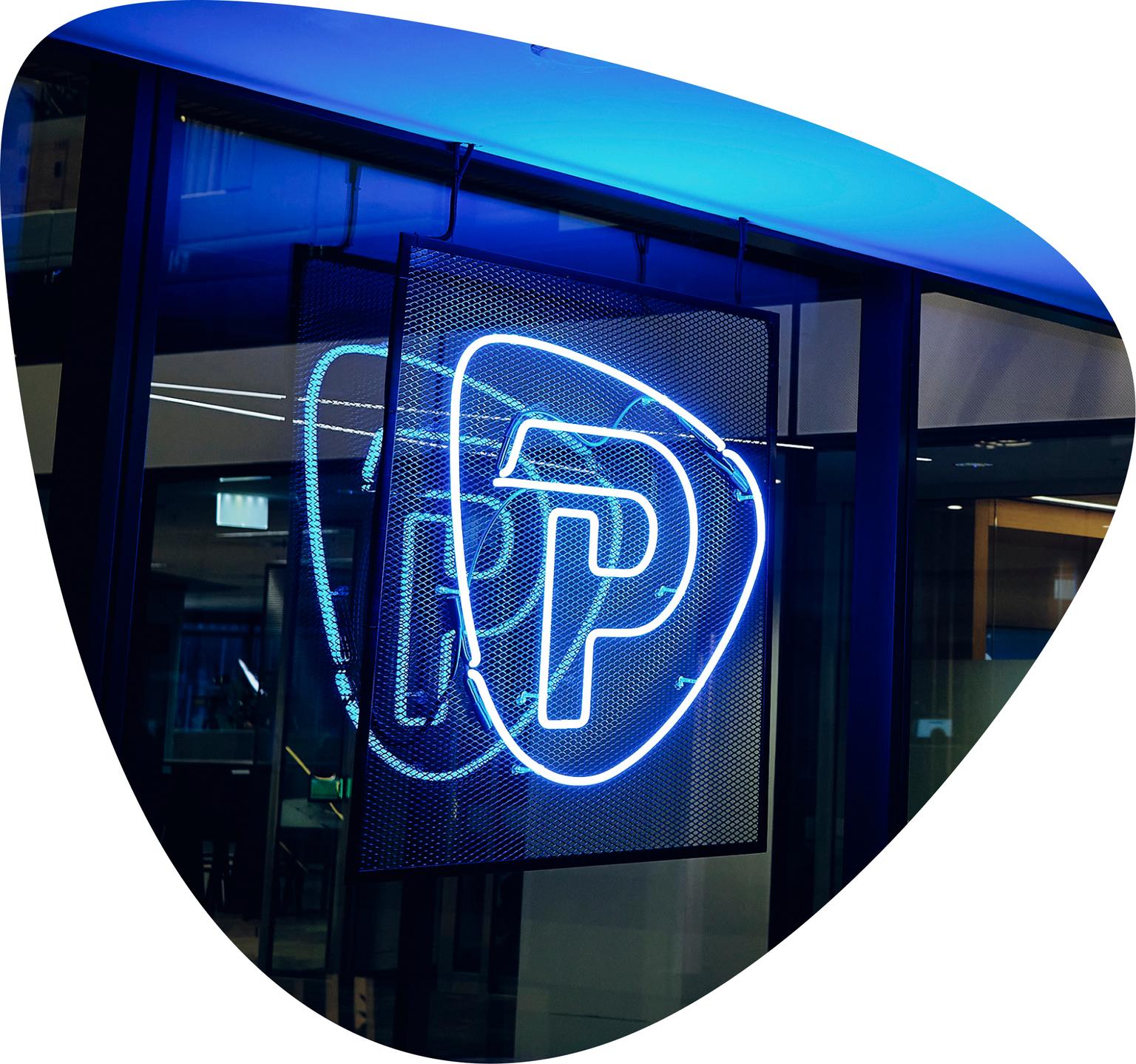 Pepperstone neon logo sign at a company office entrance