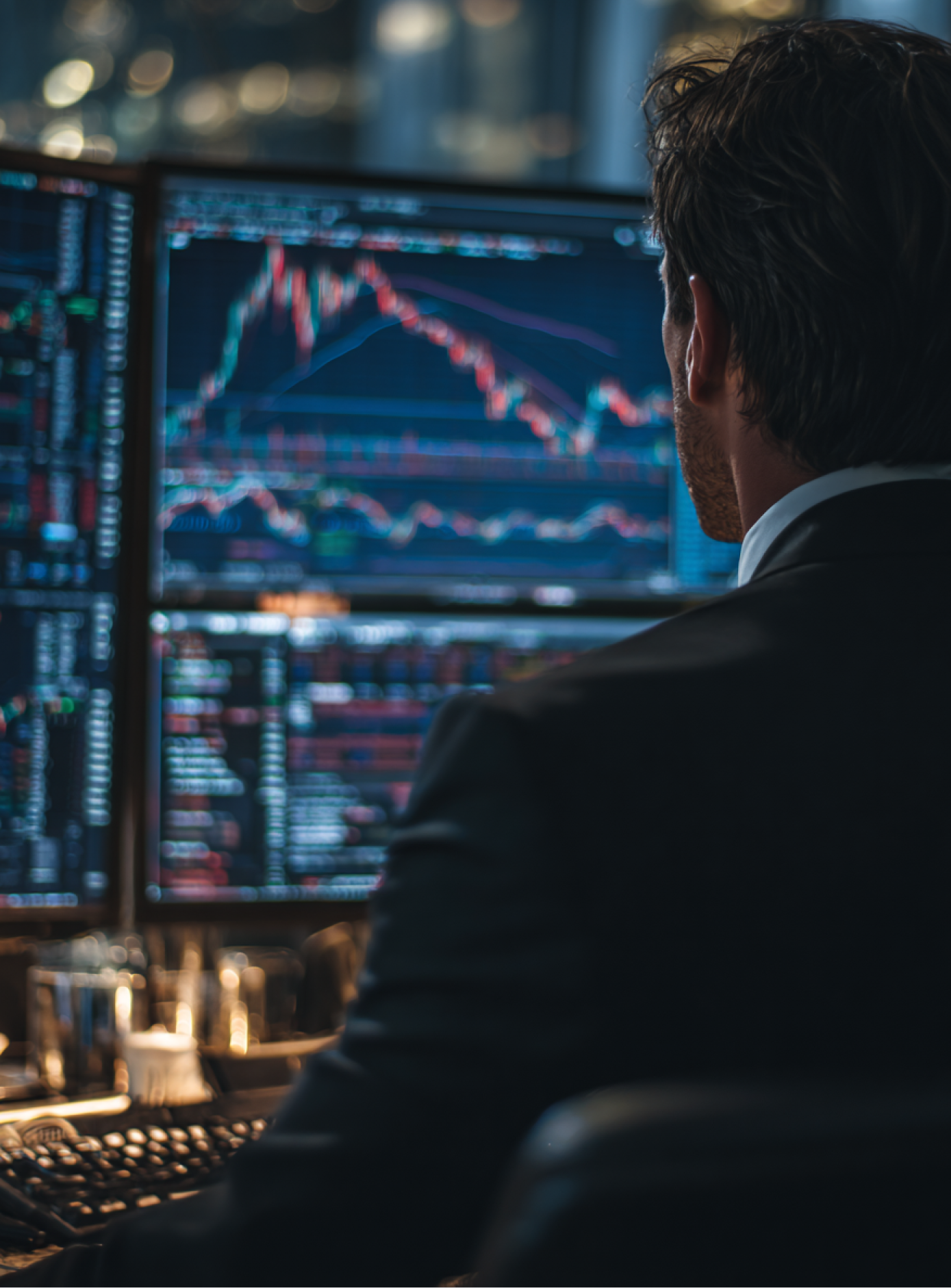 A trader monitoring multiple screens displaying financial charts