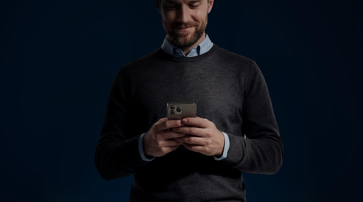 Man with black jersey on mobile