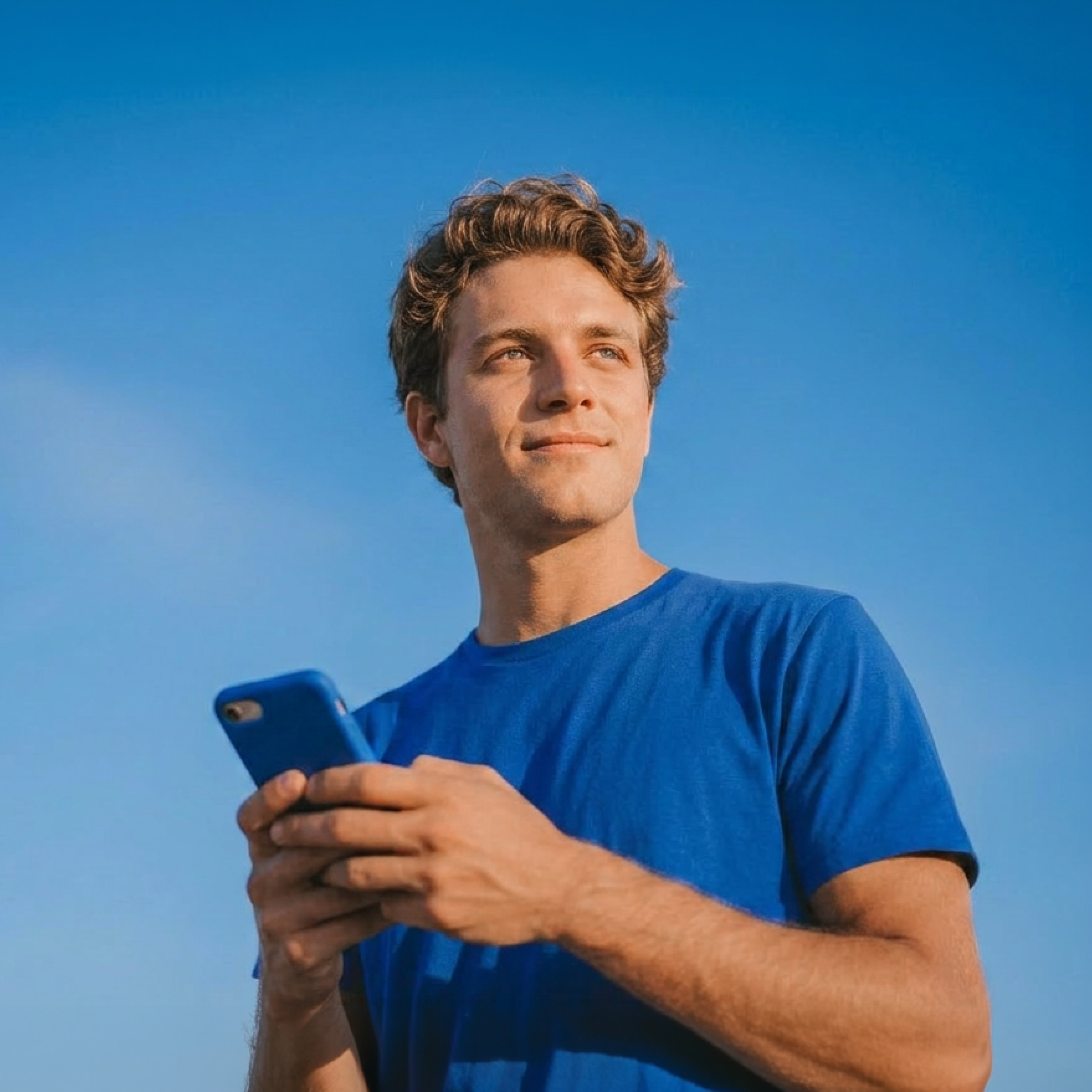Man on phone with blue shirt
