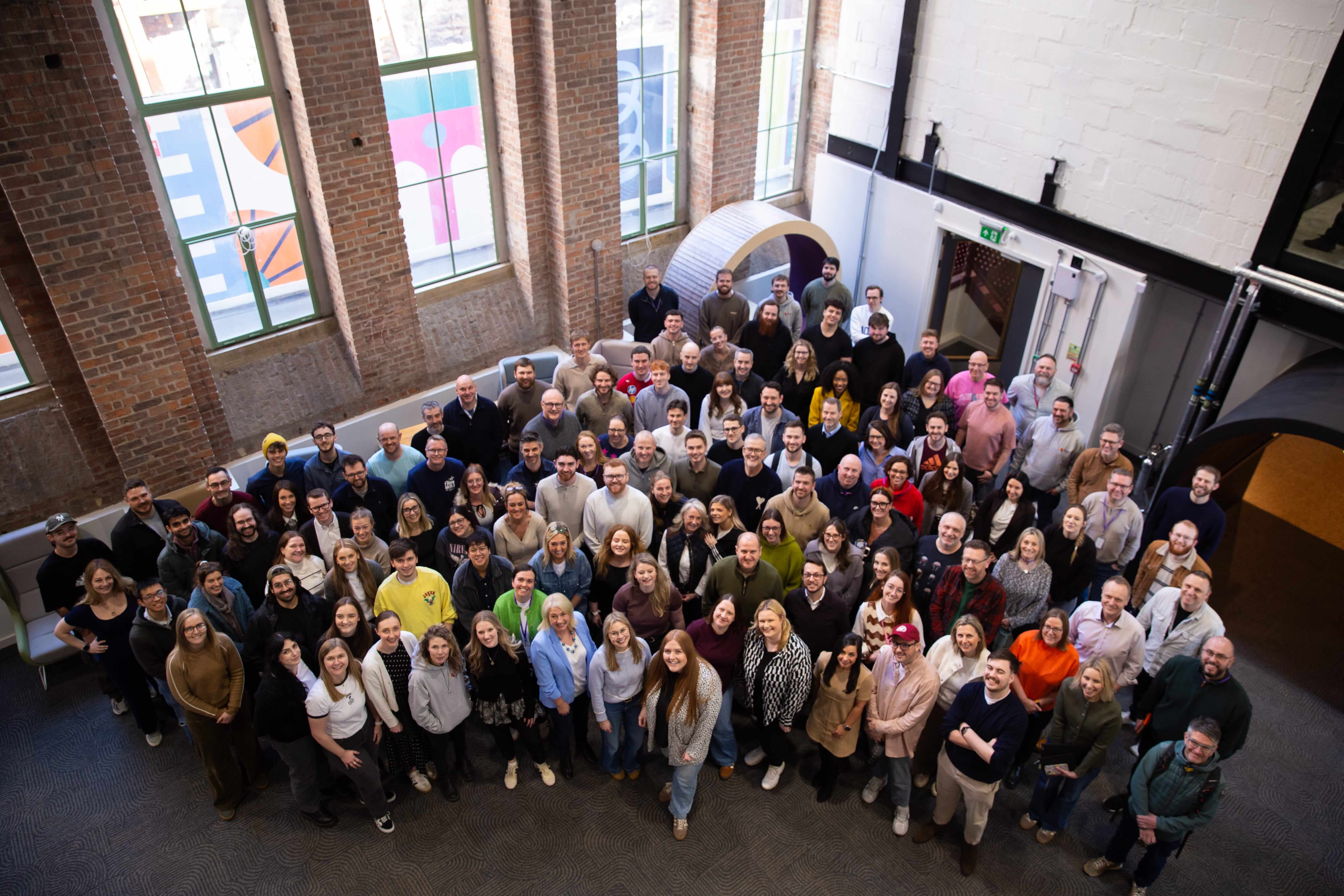 Group photo of Atom Bank staff in the Atom headquarters at the Pattern Shop