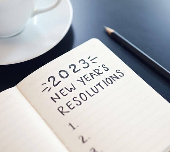 A notepad on a desk with a list titled '2023' with items being ticked off
