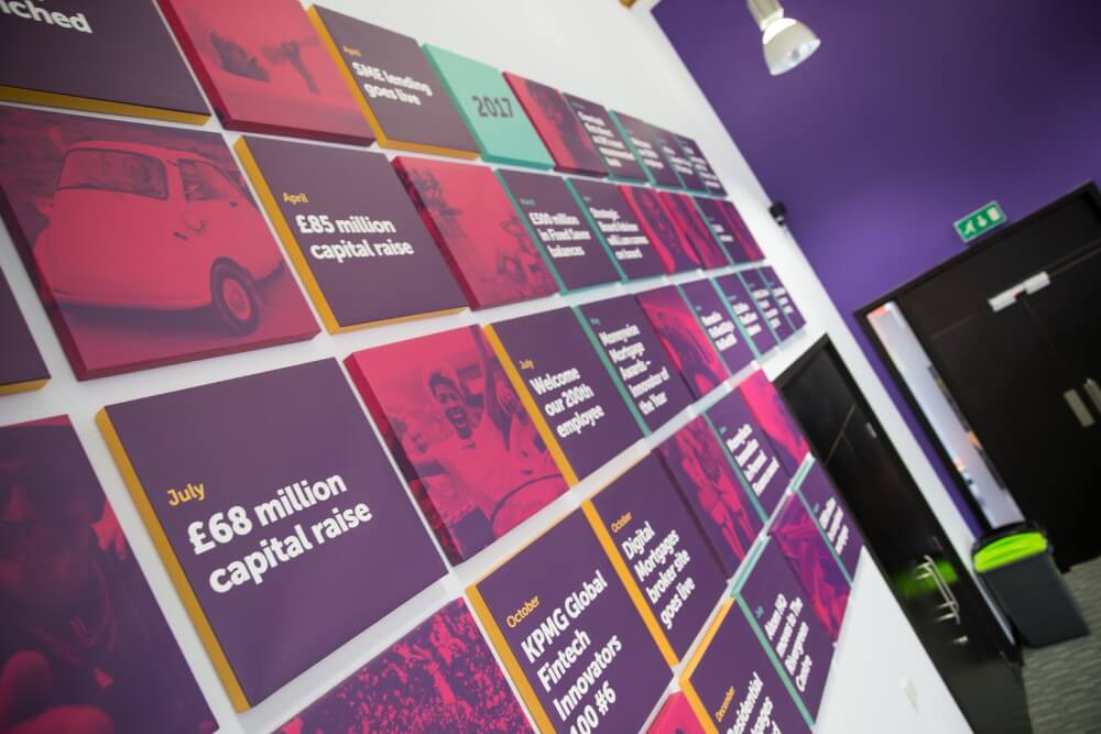 Plaques displayed on a wall within Atom HQ