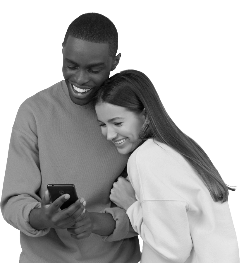 A man and woman both looking at a mobile phone and smiling