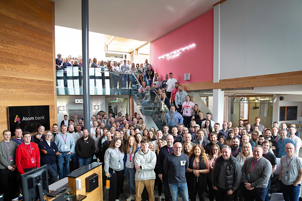 Group photo of Atom Bank staff in the office reception area at rivergreen