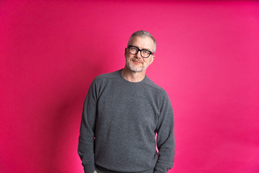 A picture of Mark Mullen with a pink background