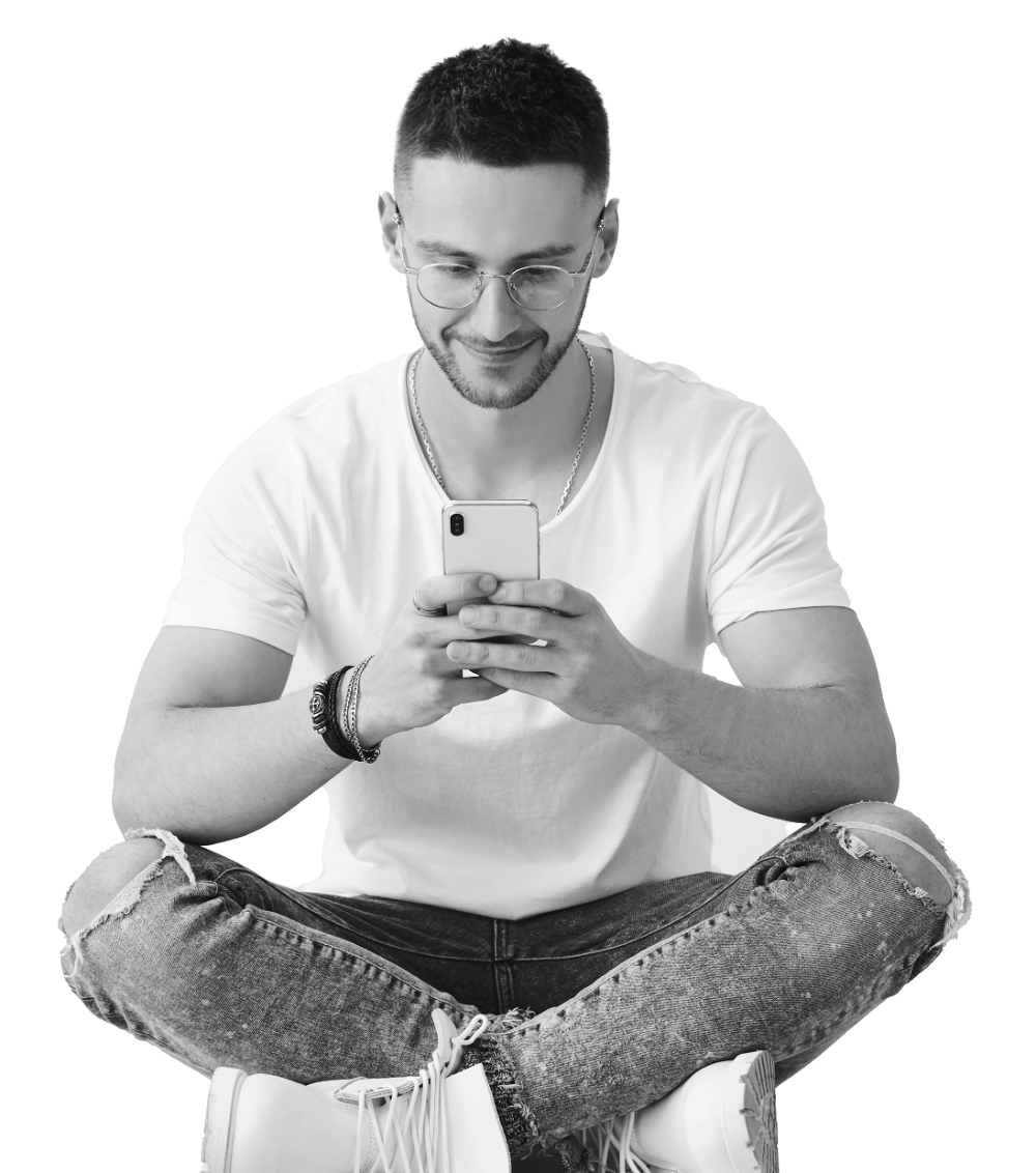 Man sitting cross-legged looking at phone