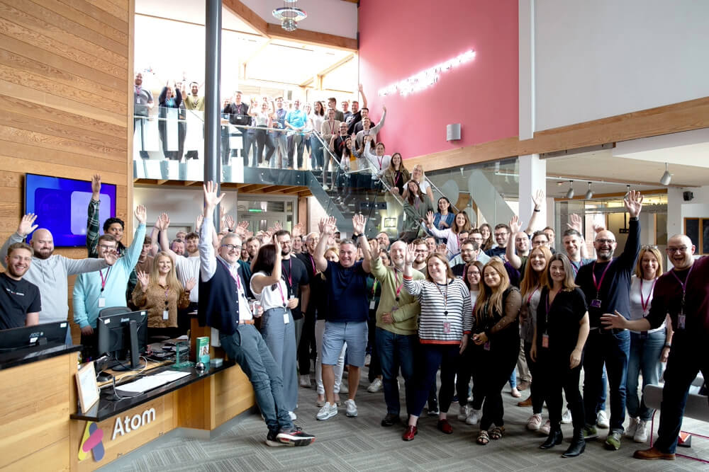 Group photo of Atom Bank staff in the office reception area at rivergreen