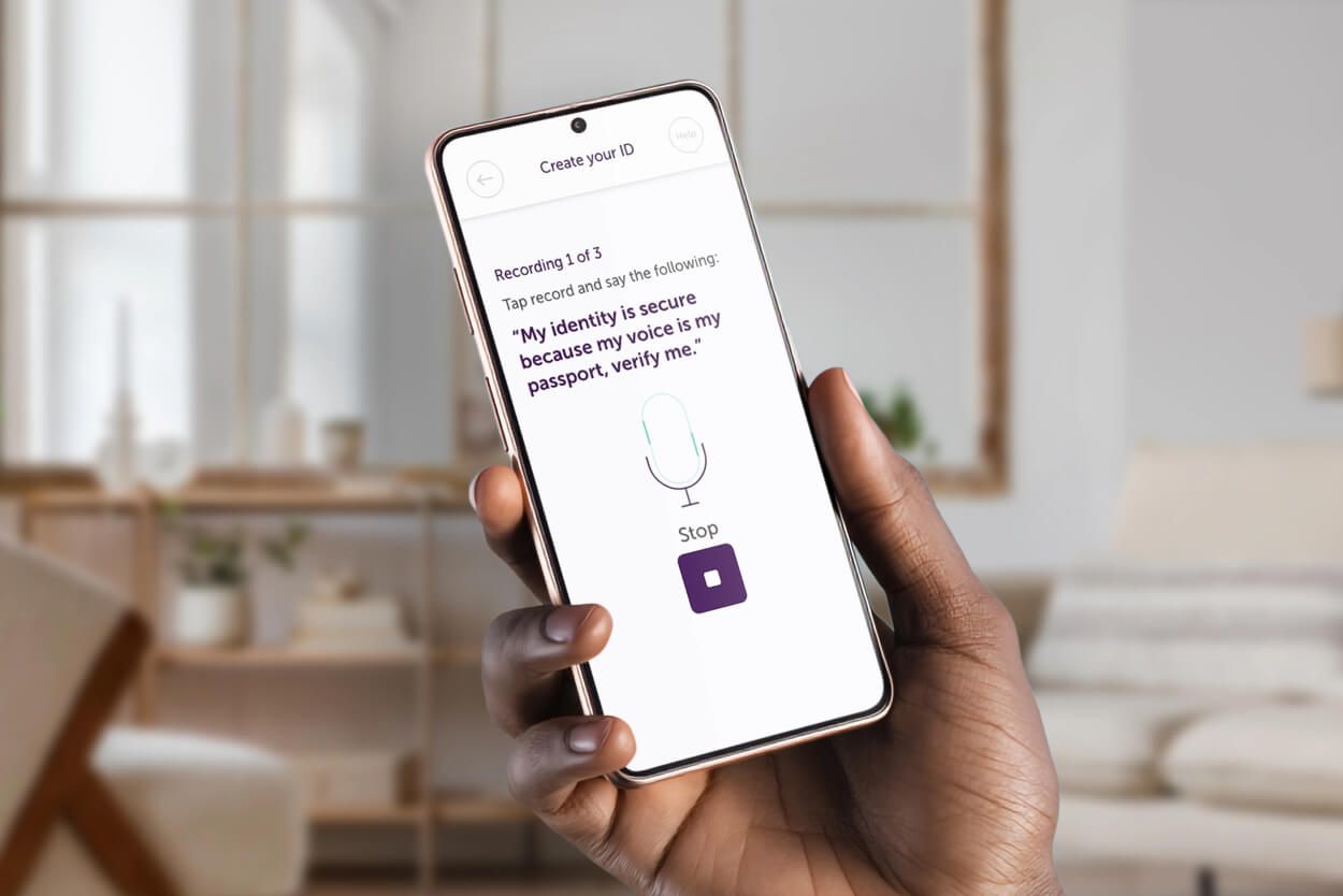 A hand holding a phone that displays the create id page on the Atom Bank app