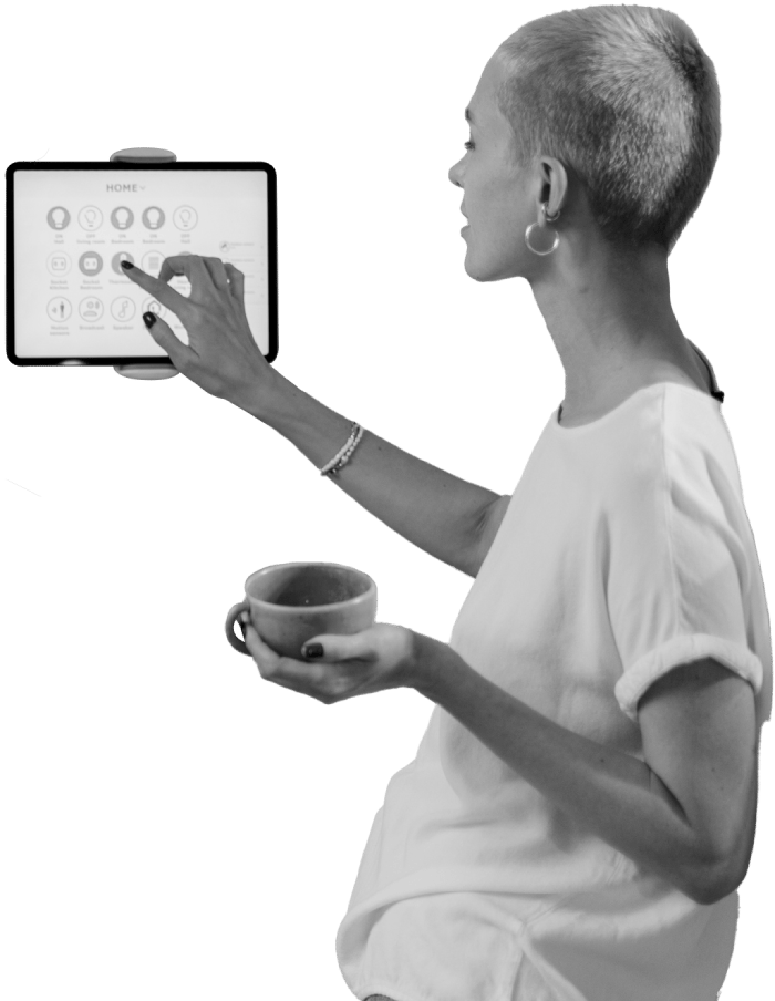 Person holding mug uses touchscreen, which shows a home page
