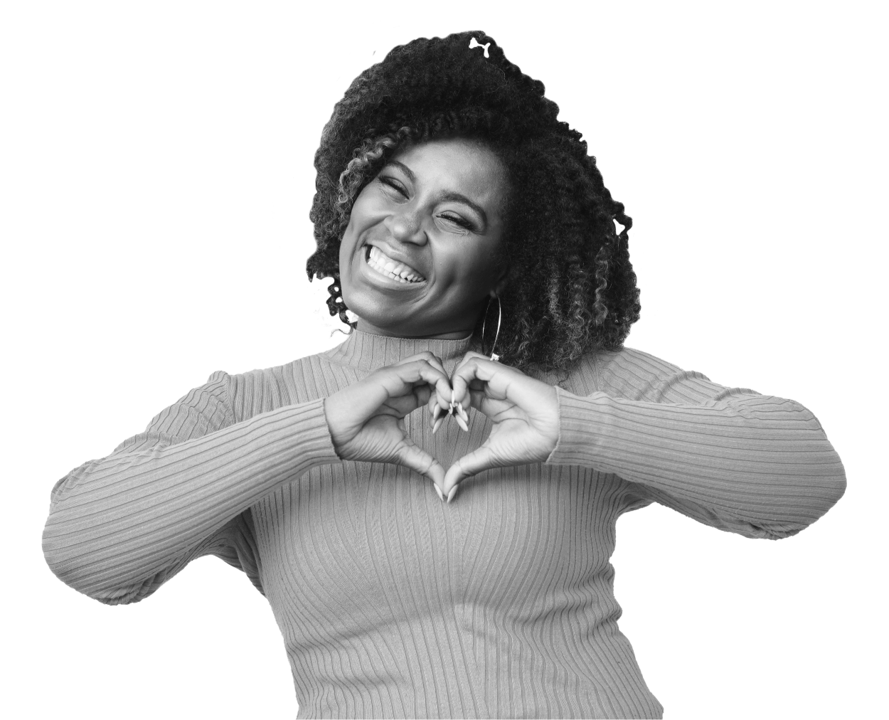 A woman is smiling whilst creating a love heart sign with her hands