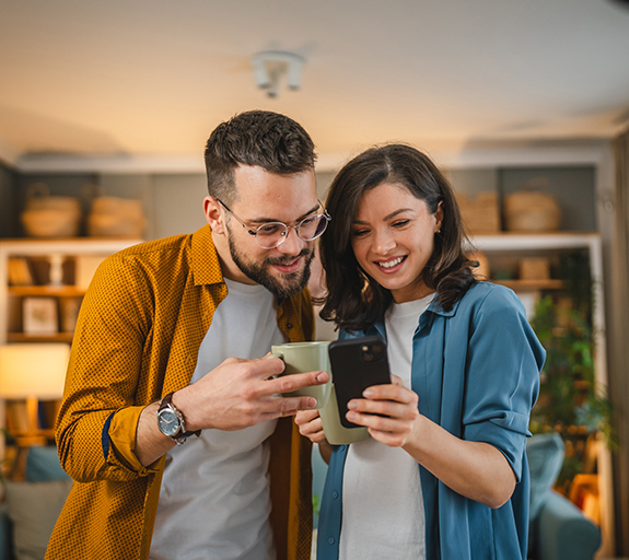 Man and woman look at their savings on phone 