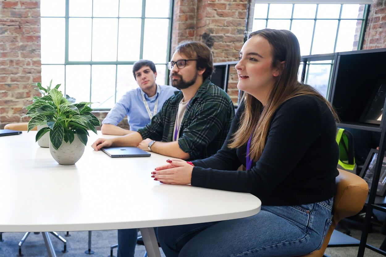 A group of people sat around a table talking