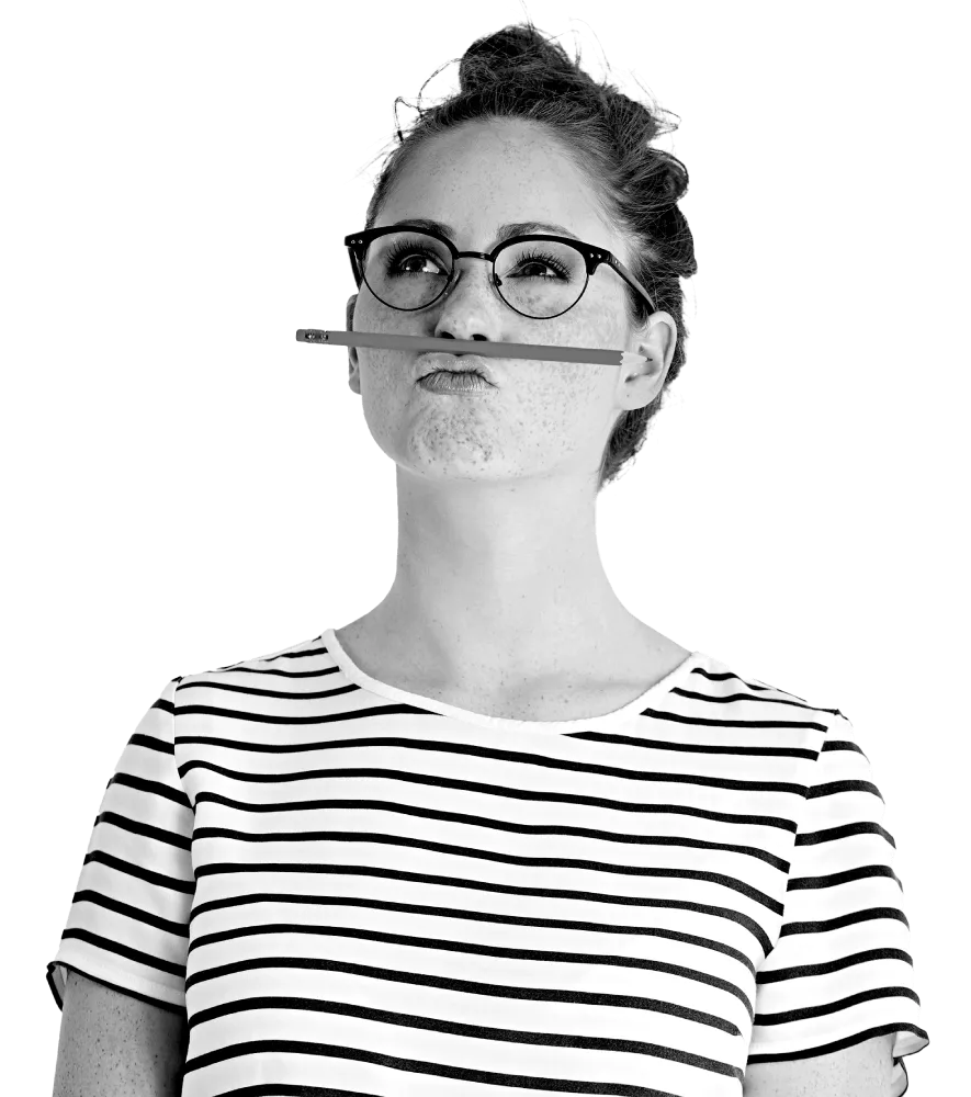 A woman with a pencil between her mouth and nose