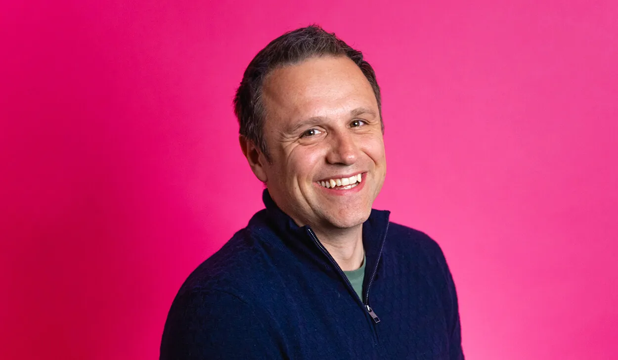 Profile of Andrew Marshall, Atom Interim CEO, against a pink background