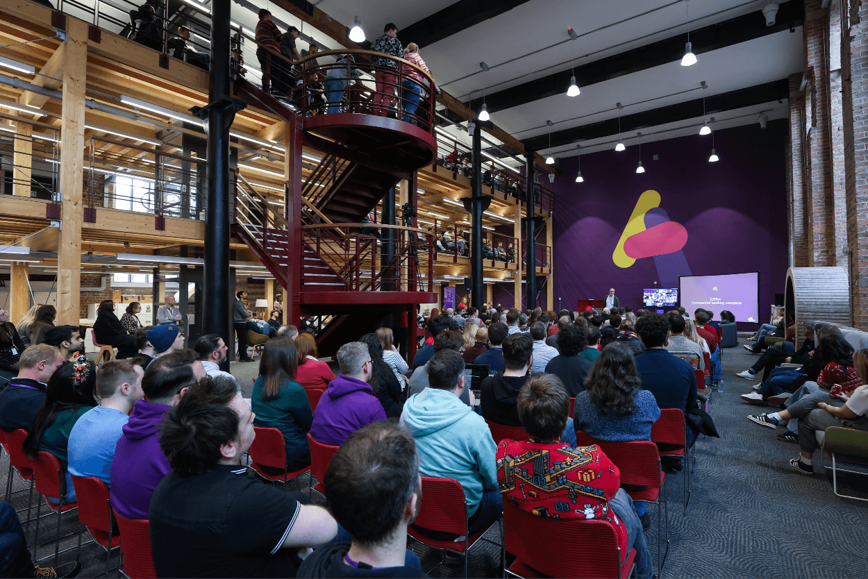 Staff sitting in a big company meeting
