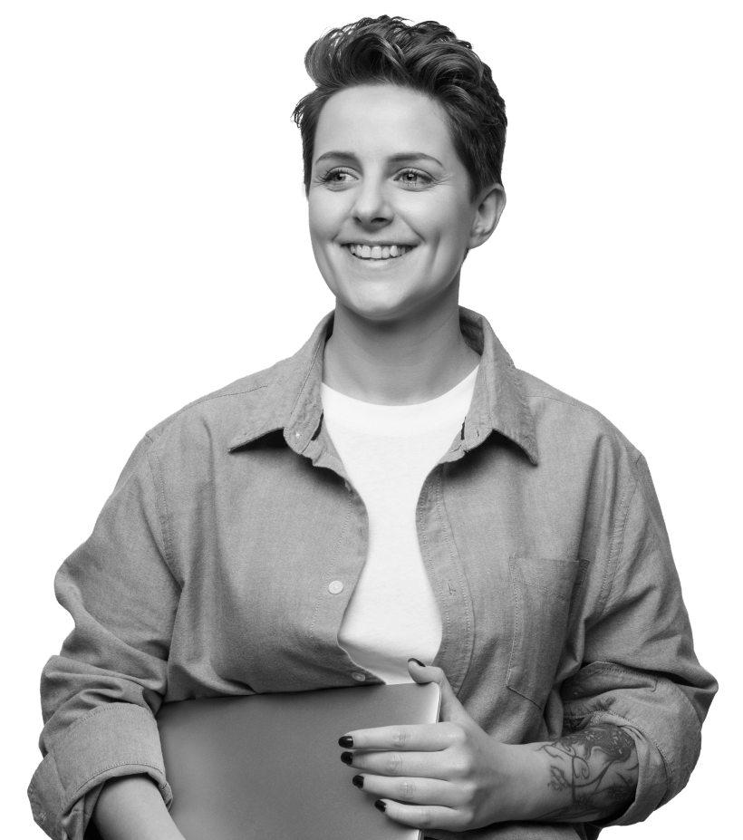 A woman holding her laptop and smiling