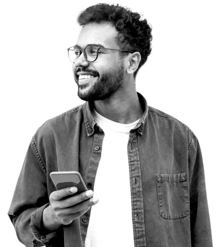 Man smiling looking away from phone