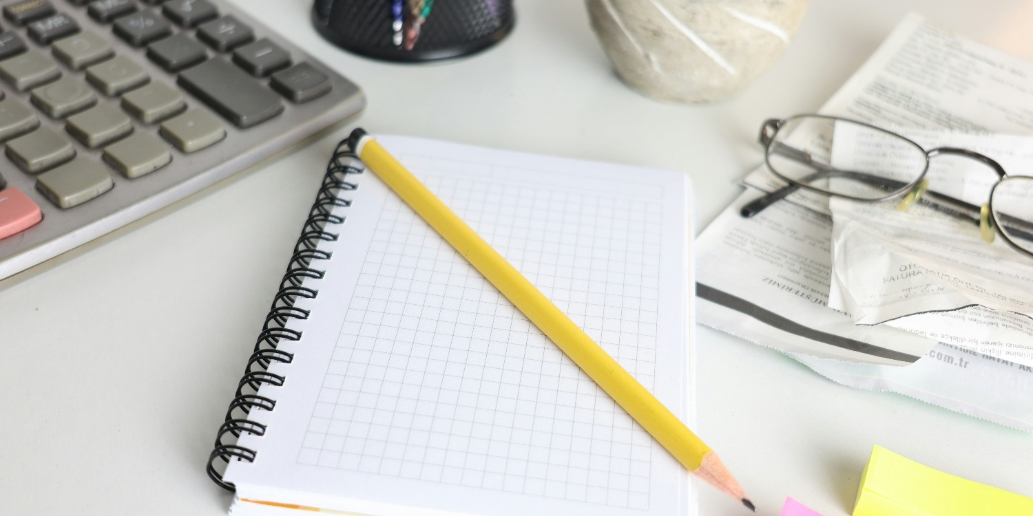 A notepad, pencil and calculator