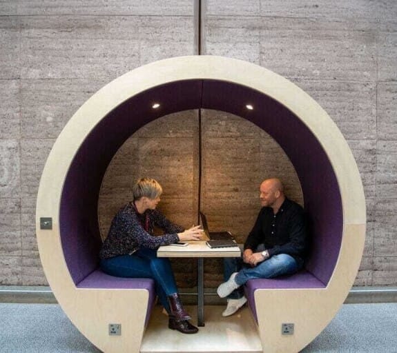 A booth at Rivergreen with two people in it working together