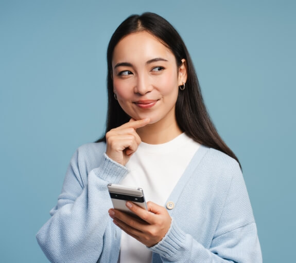 Woman stands holding her phone with a perplexed look. Around her are a lot of numbers and a heart beat wave. The words read The psychology of savings