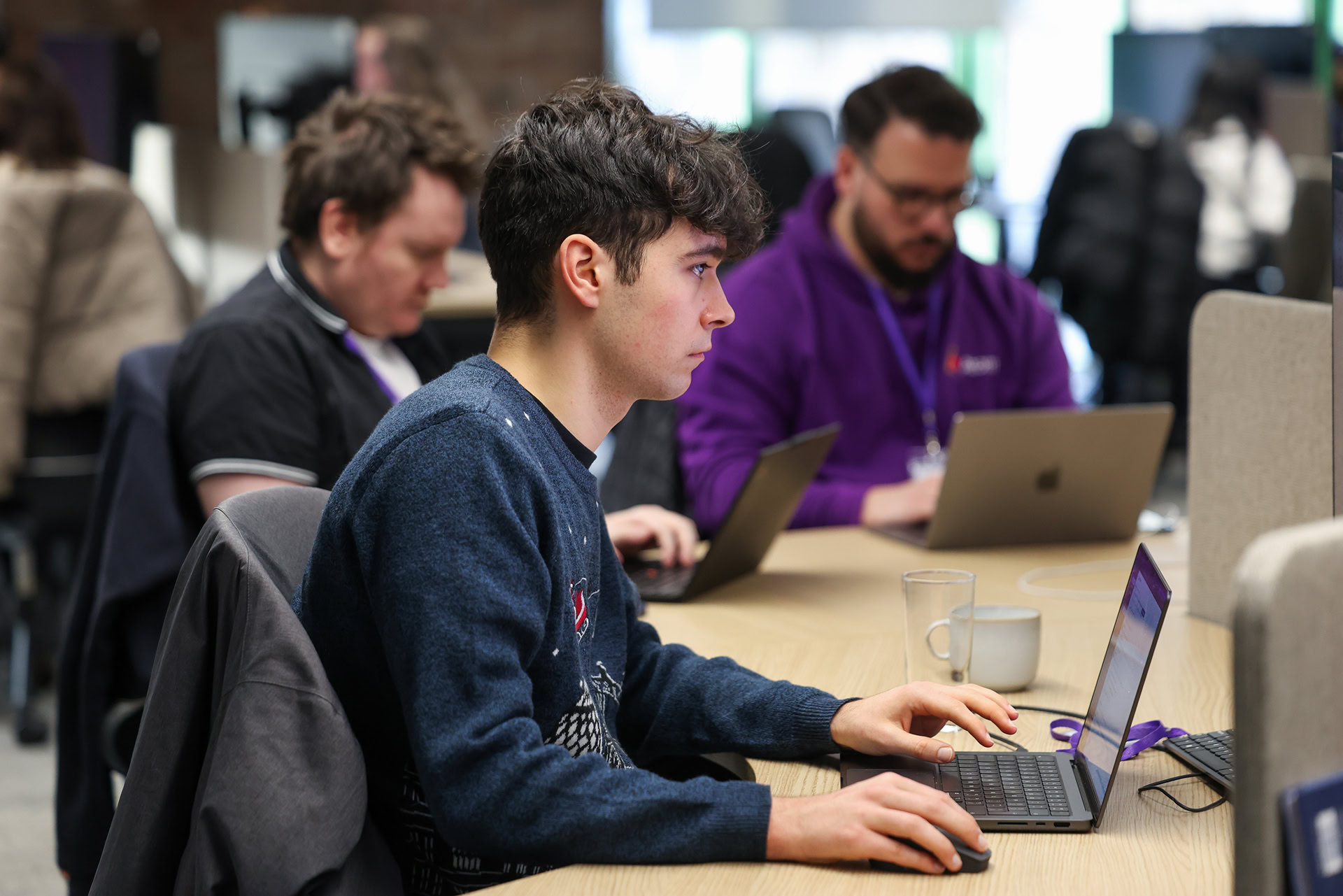 A person sitting at his desk and working on his computer