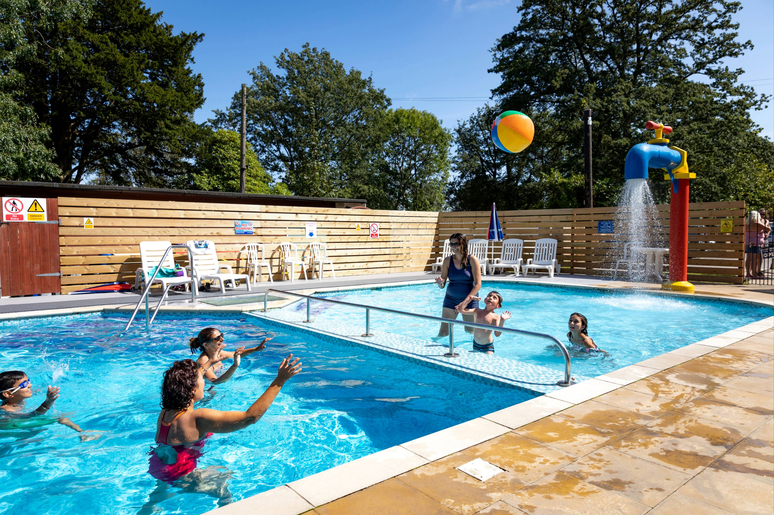 Family and friends playing in swimming pool