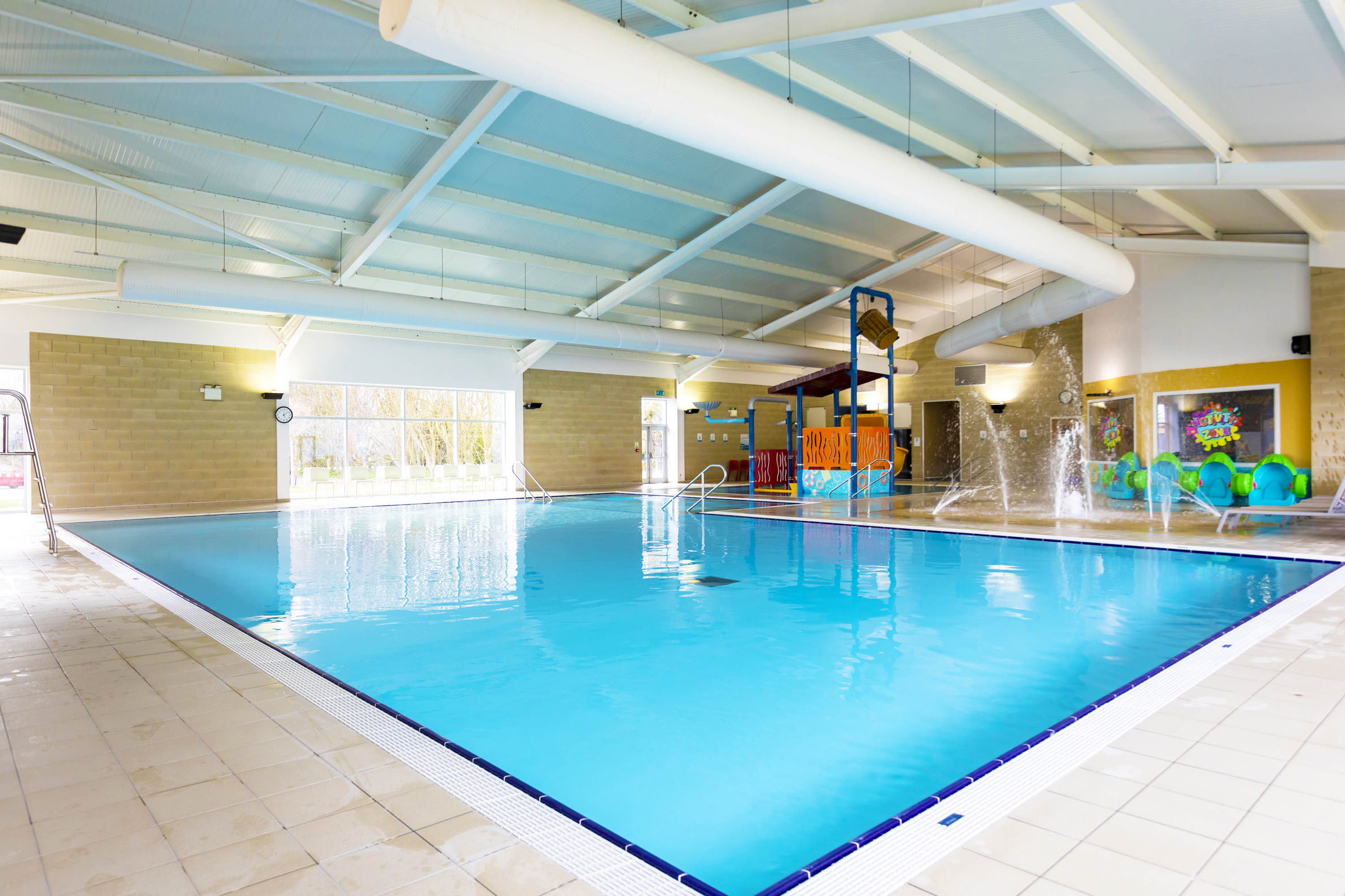 Indoor pool at Sand Le Mere in Yorkshire featuring splash zone and kids slide