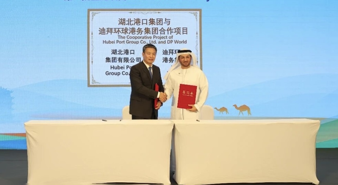 two men shaking hands behind a table