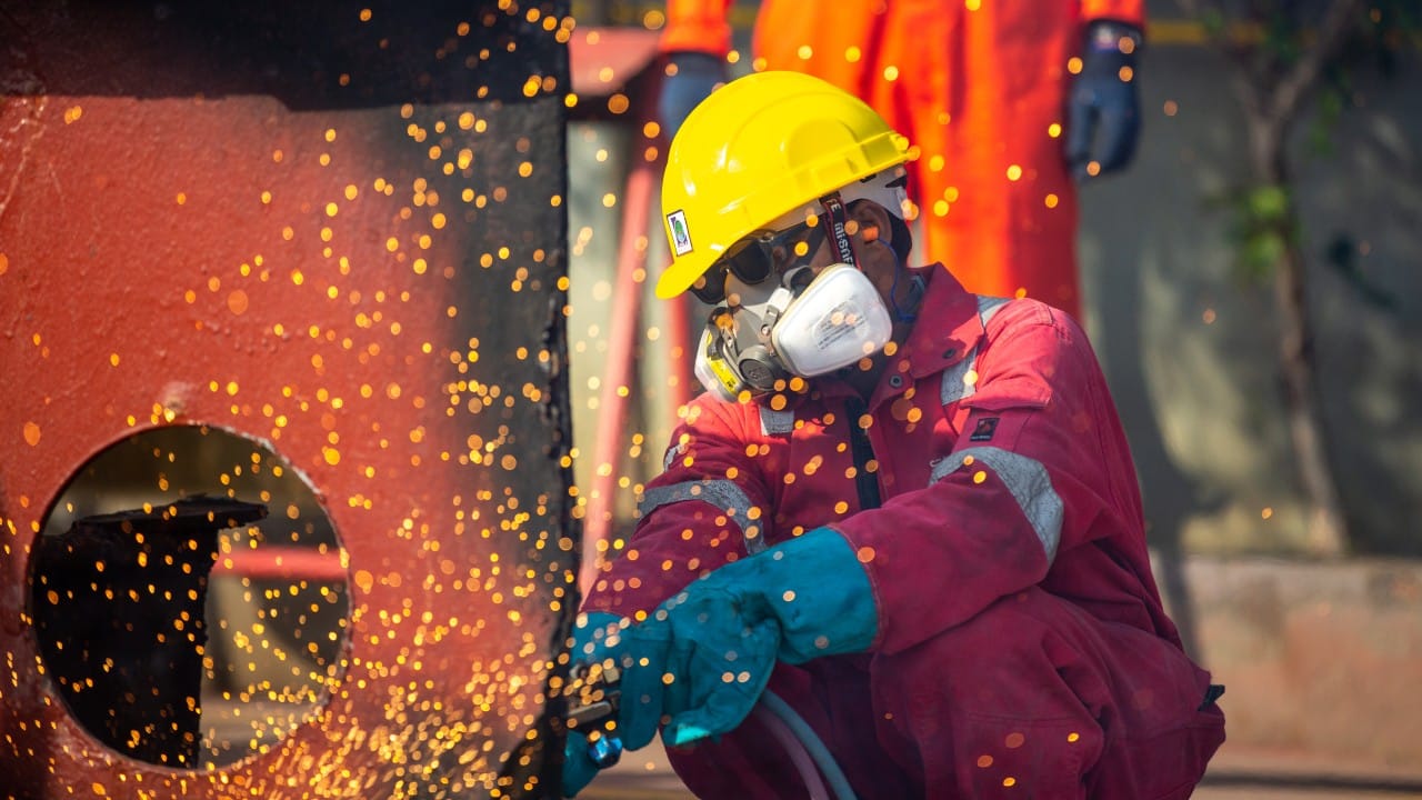 A ship recycling worker in yellow safety helmut