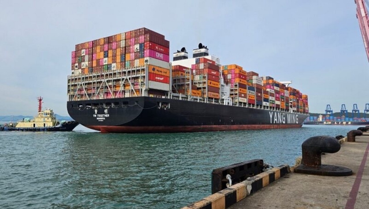 A container ship with black coloured hull