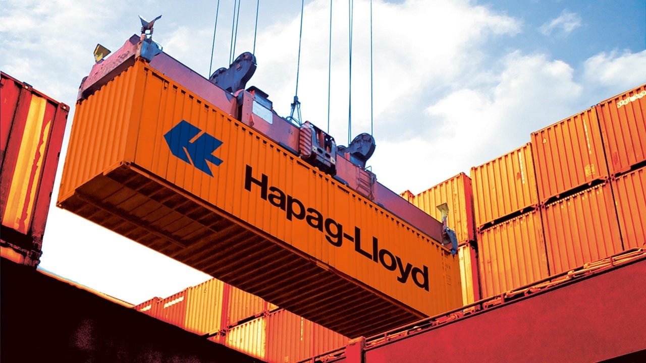 Orange container being loaded onto a ship