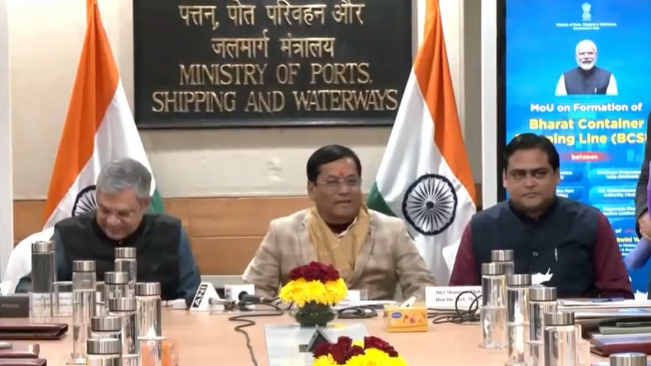 Three officials sat at a table to sign agreement