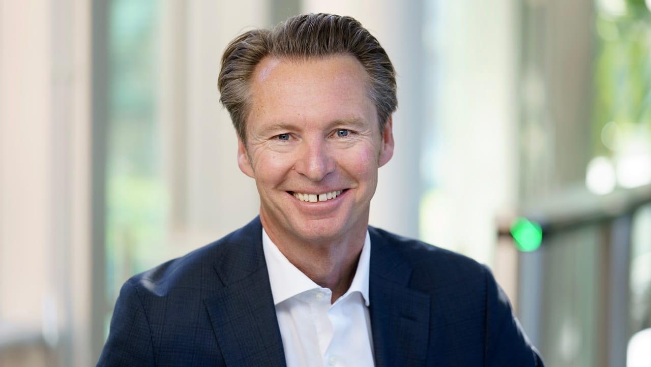 man smiling in white shirt and tie