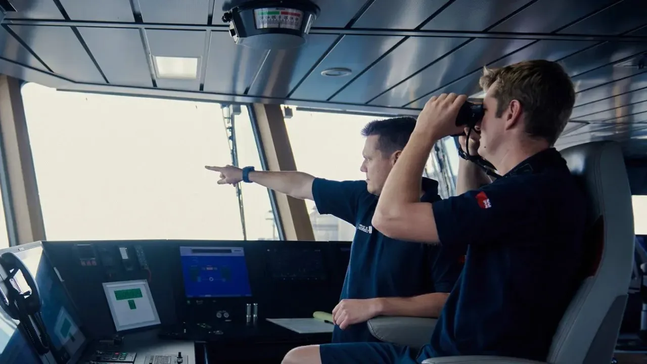 Two officers on a ship bridge