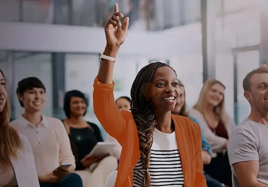 A South African couple walk and smile together after investing in Old Mutual Bula Tsela shares. A Black couple walk and smile together though a South African township.